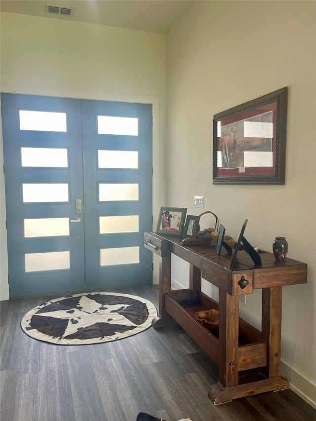 foyer entrance with french doors, dark wood-type flooring, visible vents, and baseboards