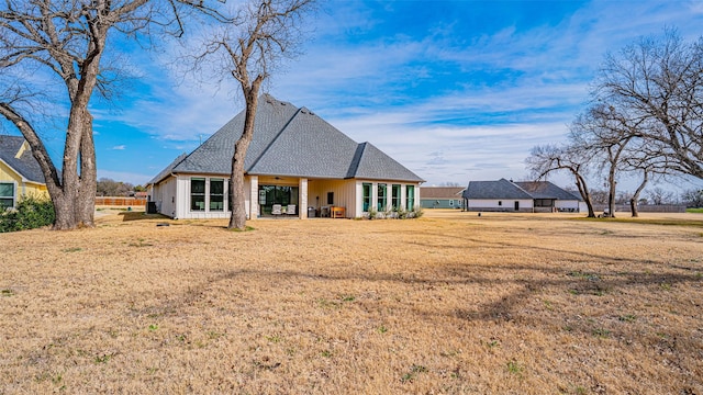 back of house with a yard