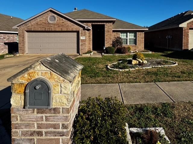 single story home featuring a garage and a front lawn