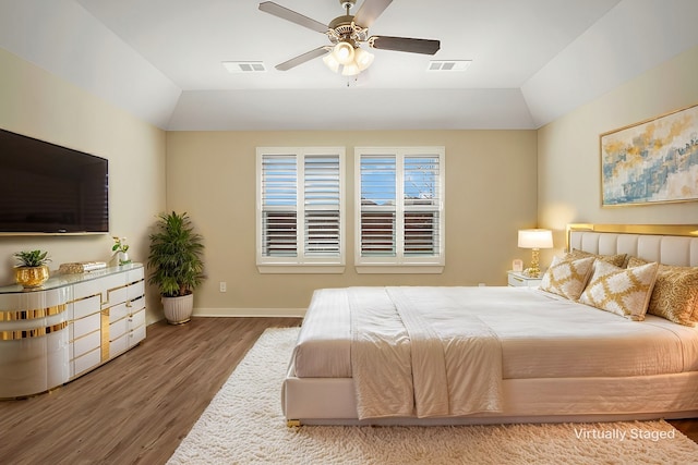 bedroom featuring vaulted ceiling, hardwood / wood-style floors, and ceiling fan