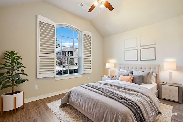 bedroom featuring vaulted ceiling, ceiling fan, and light wood-type flooring