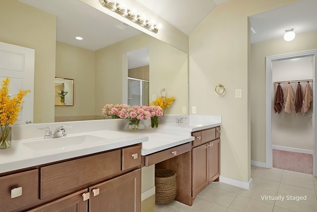 bathroom with tile patterned flooring, vanity, and a shower with shower door