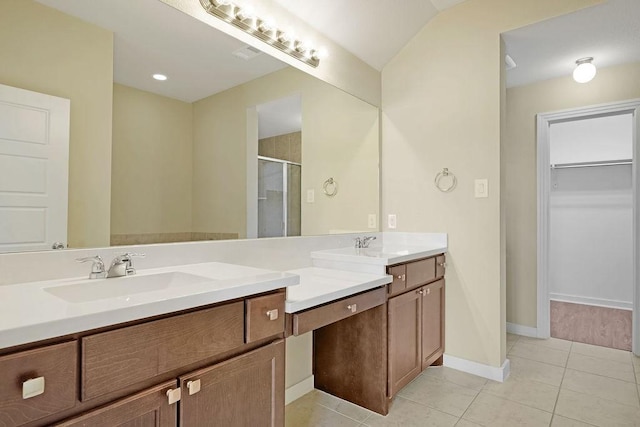 bathroom featuring vanity, a shower with door, and tile patterned floors