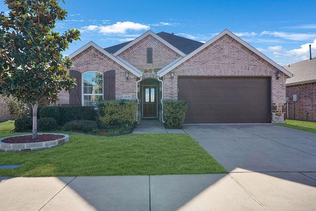 view of front of house with a garage and a front lawn