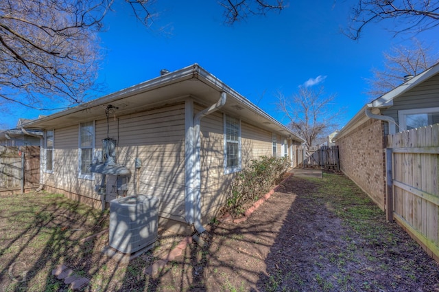 view of side of home with central AC unit