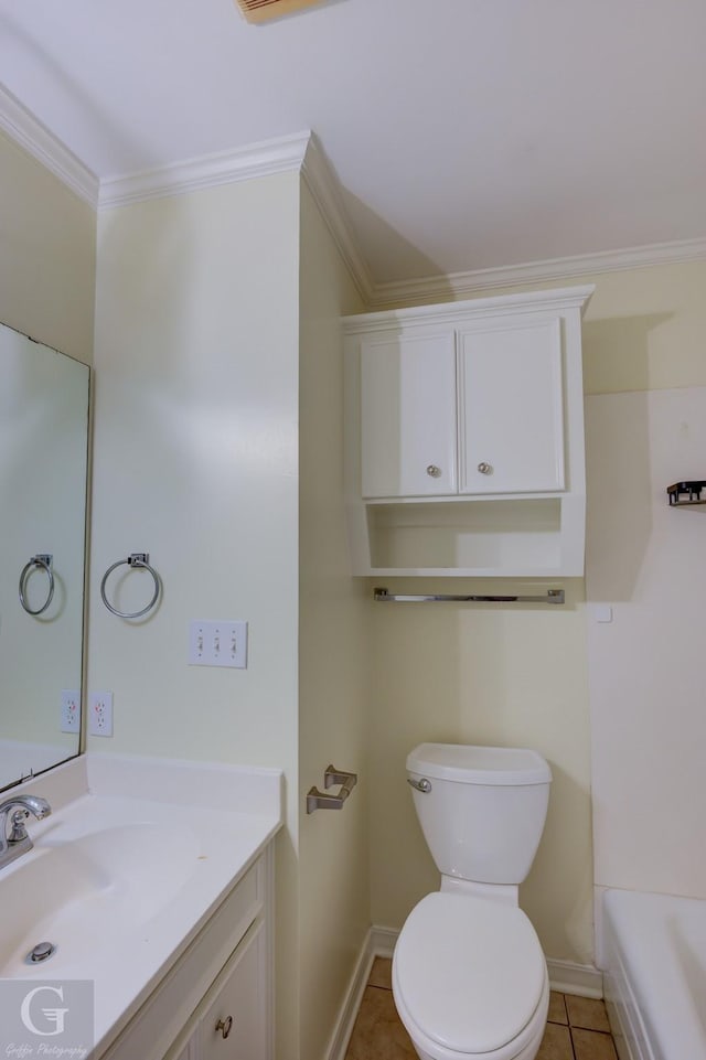 bathroom with tile patterned floors, toilet, ornamental molding, vanity, and a tub