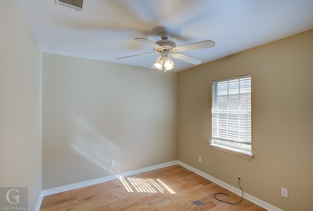 unfurnished room with ceiling fan and light wood-type flooring