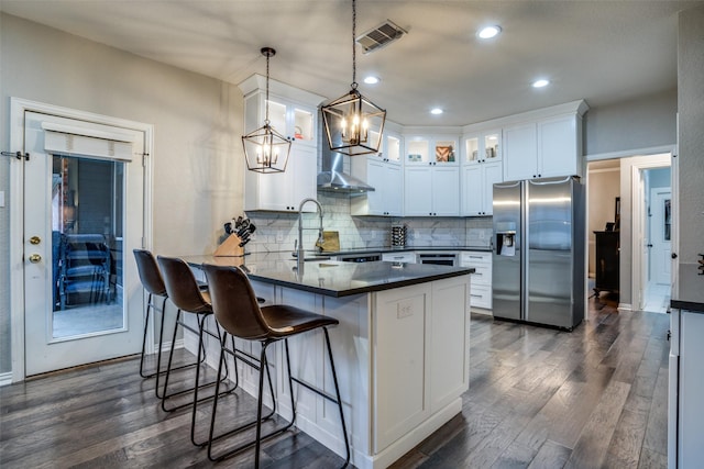 kitchen with sink, hanging light fixtures, dark hardwood / wood-style flooring, stainless steel appliances, and white cabinets