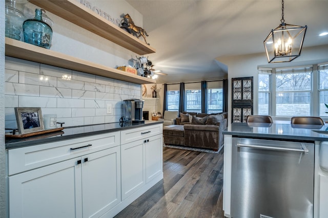 kitchen featuring hanging light fixtures, dishwasher, white cabinets, and decorative backsplash