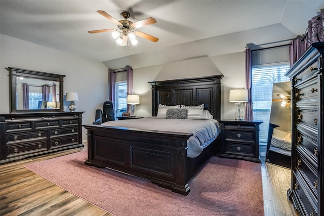 bedroom featuring hardwood / wood-style flooring, ceiling fan, and lofted ceiling