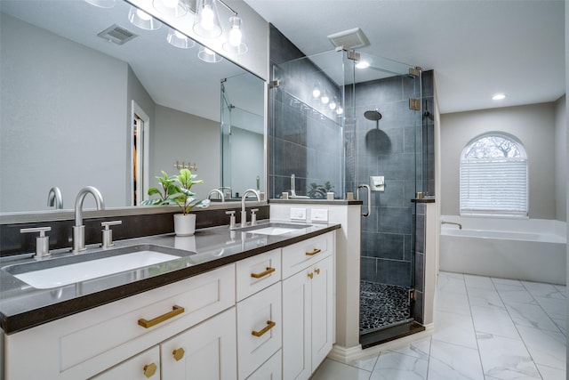 bathroom featuring shower with separate bathtub and vanity