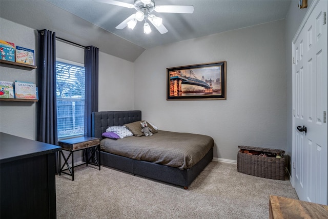 carpeted bedroom with ceiling fan, vaulted ceiling, and a closet