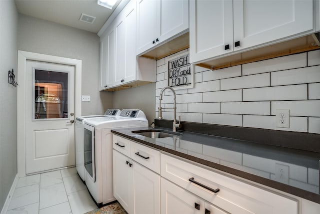 laundry area with sink, cabinets, and washing machine and clothes dryer