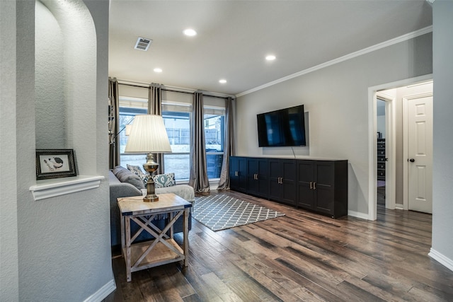 living room featuring ornamental molding and dark hardwood / wood-style flooring