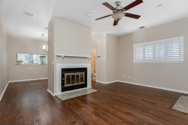 unfurnished living room featuring dark wood-type flooring, sink, and ceiling fan