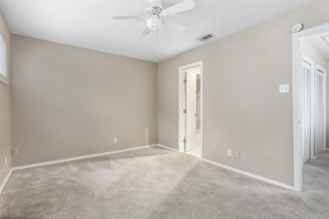 carpeted empty room with ceiling fan