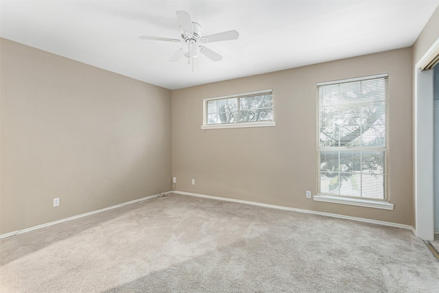 unfurnished room featuring light carpet and ceiling fan