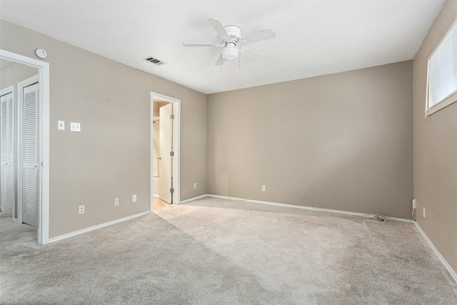 unfurnished bedroom featuring ceiling fan, connected bathroom, and light carpet