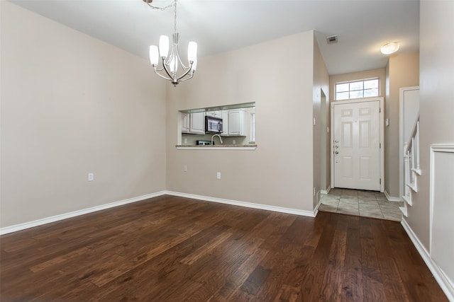 foyer featuring an inviting chandelier and wood-type flooring