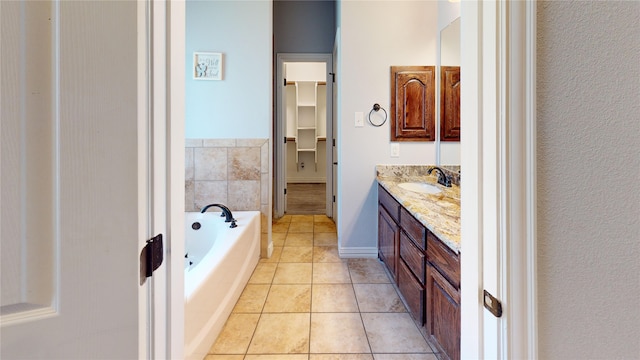 bathroom with tile patterned floors, vanity, and a bath