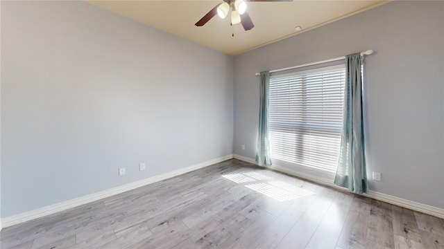 spare room with ceiling fan and light wood-type flooring