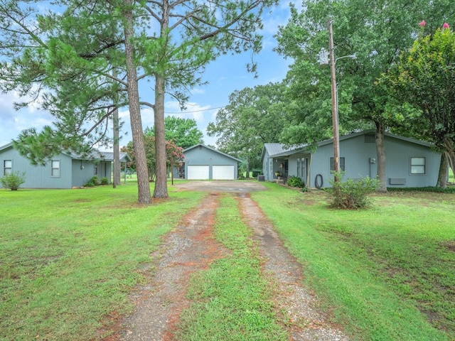 view of yard featuring a garage and an outdoor structure