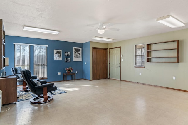 sitting room with a textured ceiling and ceiling fan