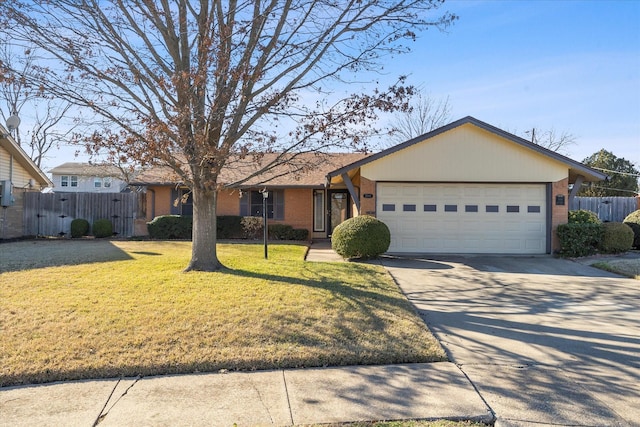 ranch-style house featuring a garage and a front yard