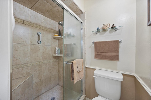 bathroom featuring toilet and walk in shower