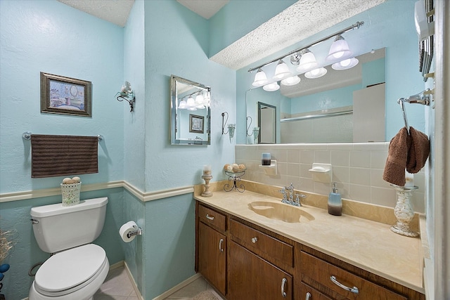 bathroom with backsplash, tile patterned flooring, vanity, an enclosed shower, and toilet