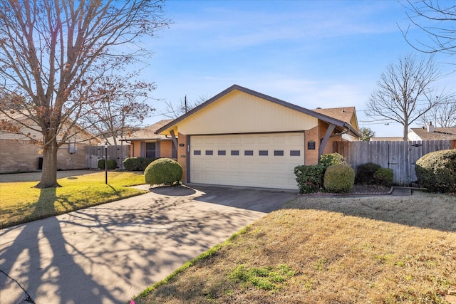 single story home featuring a garage and a front yard