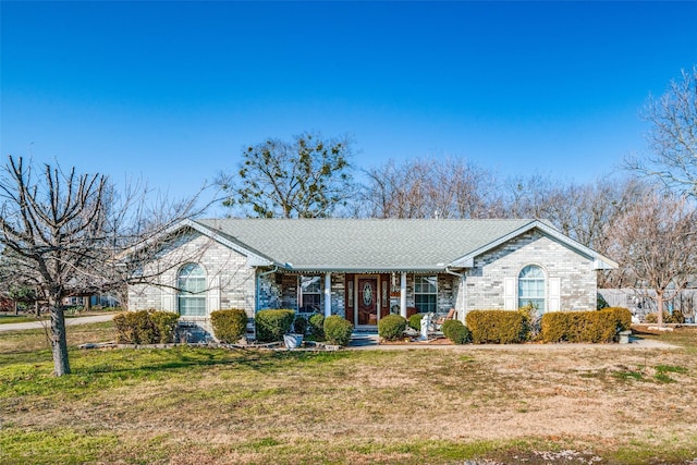 single story home with covered porch and a front lawn