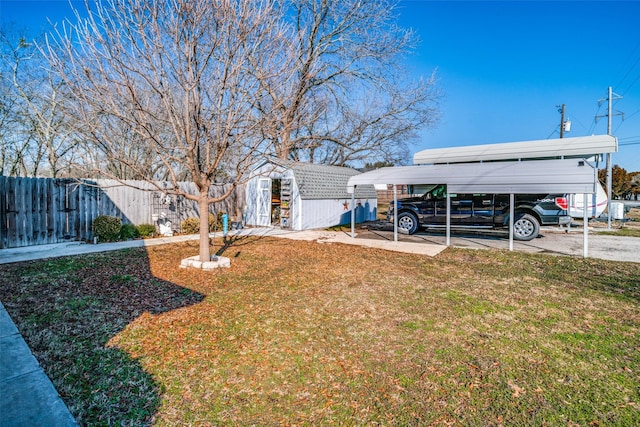 view of yard featuring a carport and a shed