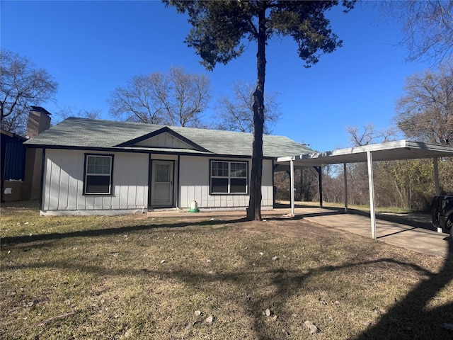 view of front of home with a carport and a front lawn