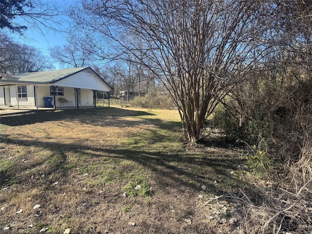 view of yard featuring covered porch