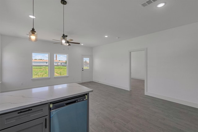 kitchen with gray cabinetry, light wood-type flooring, dishwasher, pendant lighting, and light stone countertops