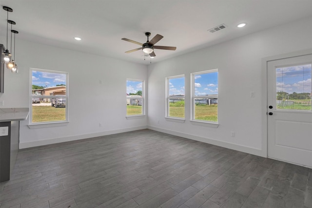 interior space with dark wood-type flooring and ceiling fan