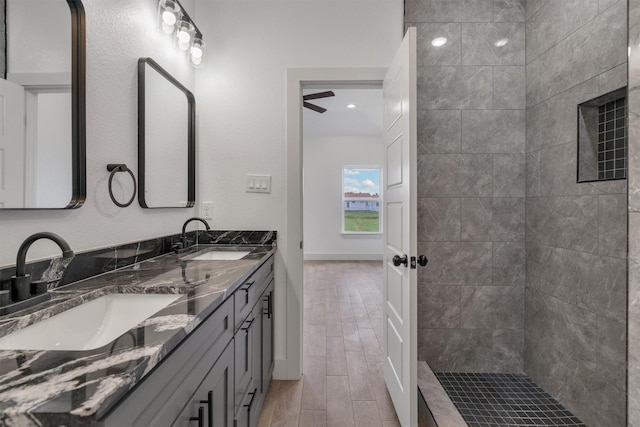 bathroom featuring vanity and tiled shower