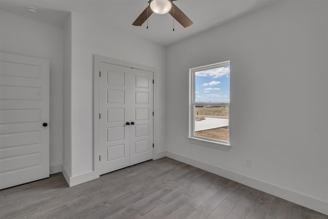 unfurnished bedroom featuring light hardwood / wood-style flooring and ceiling fan