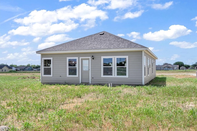 rear view of property with a lawn