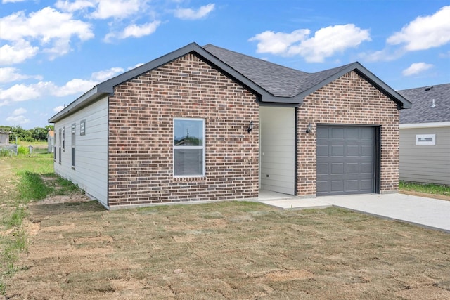 view of front of house with a garage and a front lawn