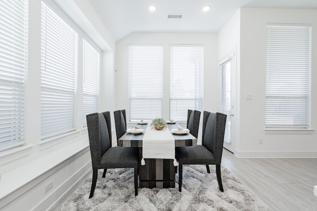 dining area with wood finished floors, baseboards, visible vents, lofted ceiling, and recessed lighting