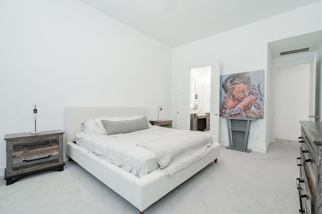 bedroom featuring light carpet, visible vents, connected bathroom, and baseboards