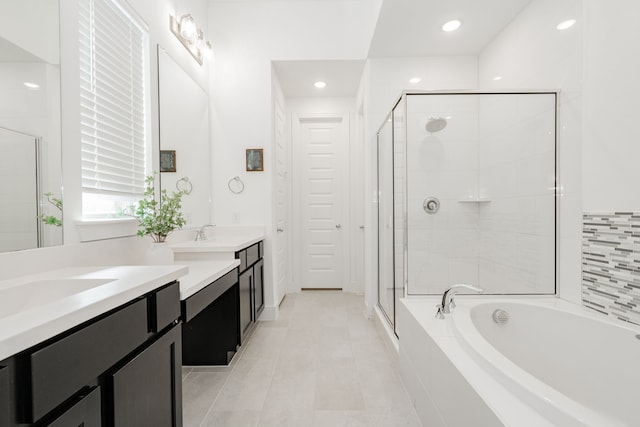 full bathroom featuring tile patterned floors, a garden tub, a stall shower, and vanity