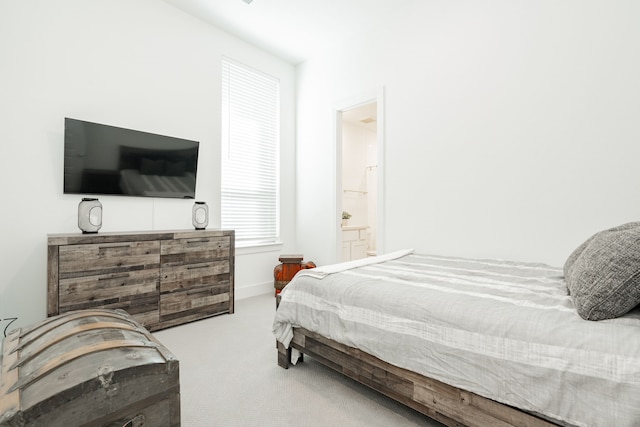 bedroom featuring carpet flooring, connected bathroom, and baseboards