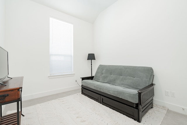 sitting room featuring baseboards and lofted ceiling