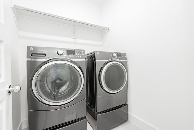 washroom featuring washing machine and dryer and laundry area