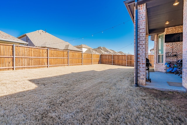 view of yard featuring a patio and a fenced backyard