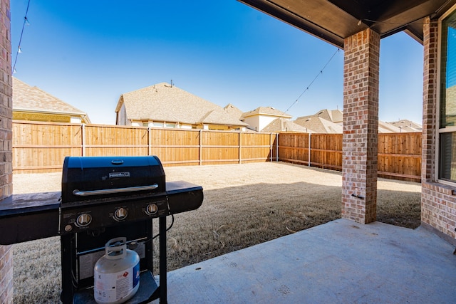 view of patio / terrace with grilling area and a fenced backyard