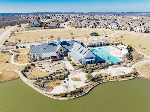 birds eye view of property with a residential view and a water view